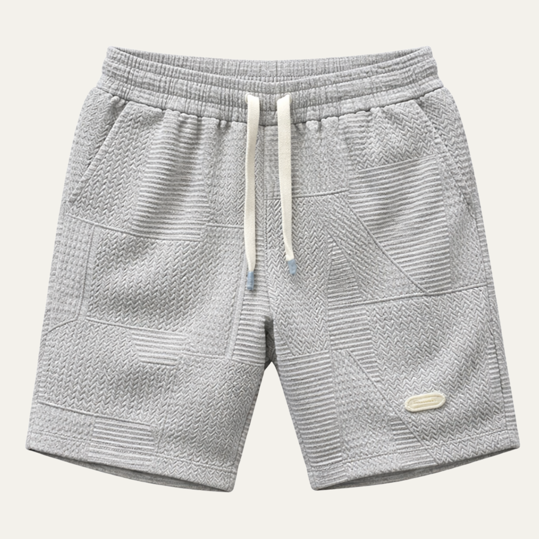 Light gray textured drawstring shorts with patchwork pattern and side pockets