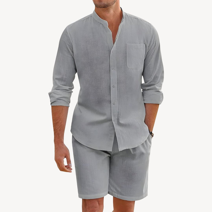Gray linen shirt shorts set for men featuring a mandarin collar, chest pocket, and rolled cuffs