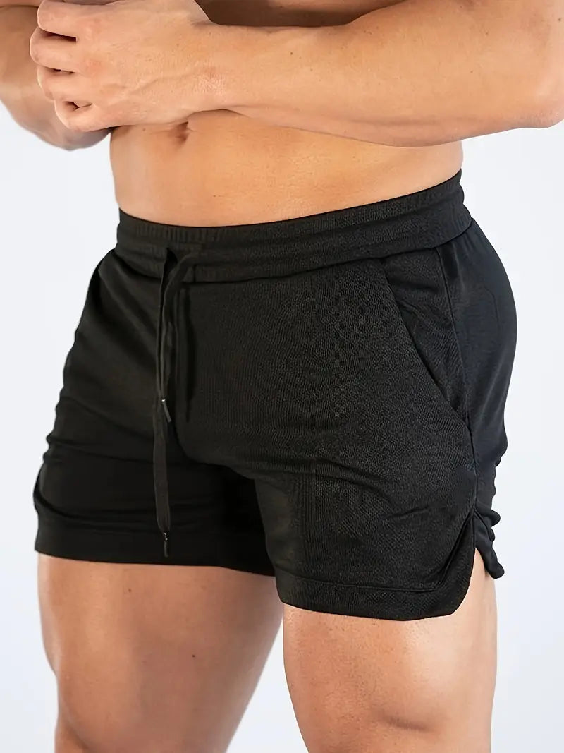 Black men's swim shorts featuring quick dry material, drawstring waistband, side pocket and split hem