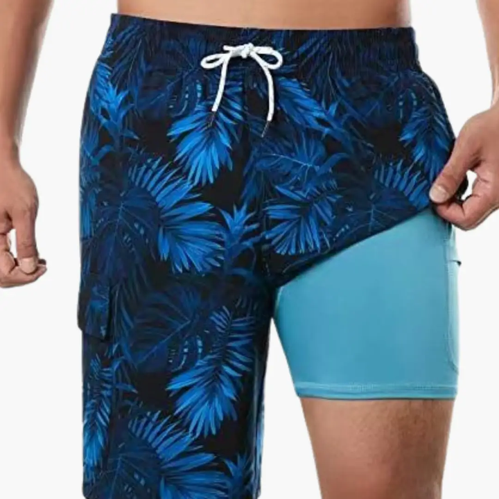 Dark blue men's swim shorts with bright leaf print and light blue mesh lining