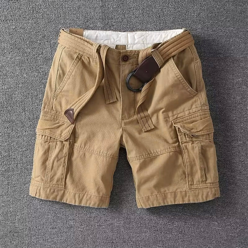Beige linen shorts with drawstring waist and cuffed hem, front close-up on white