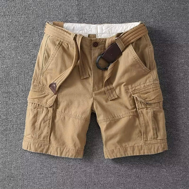 Beige linen shorts with drawstring waist and cuffed hem, front close-up on white