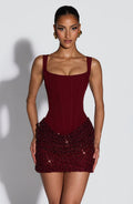 Front view of burgundy corset mini dress with square neck and glitter beaded hem