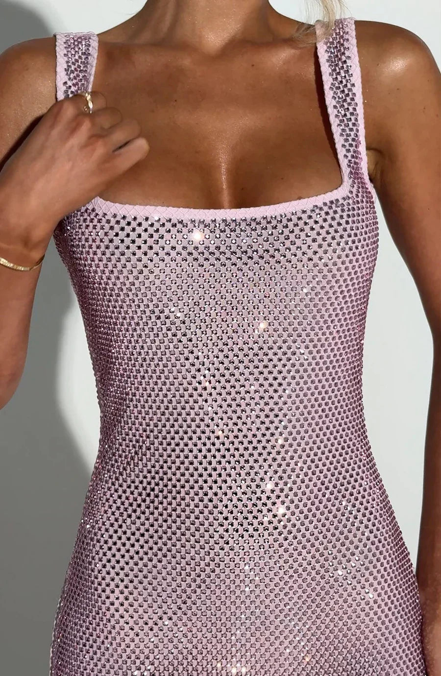 Back view of pink cocktail mini dress with open scoop back and allover rhinestone sparkle