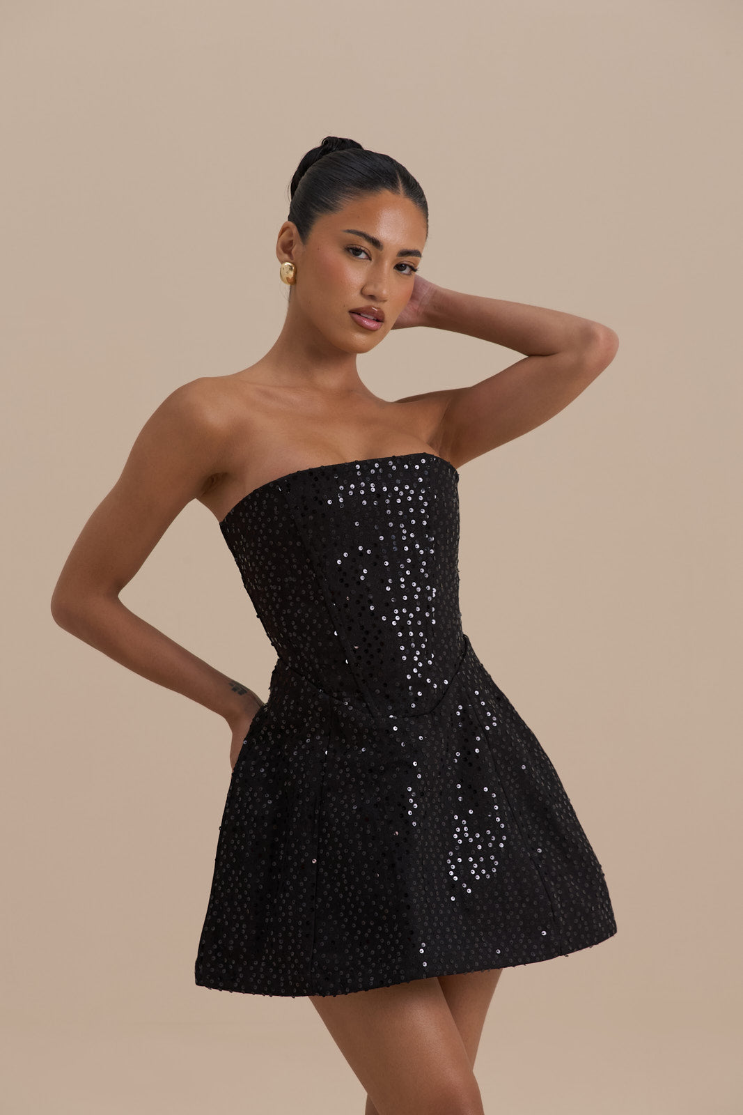 Black sequin strapless cocktail mini dress close-up showing fitted bodice and sparkle detail