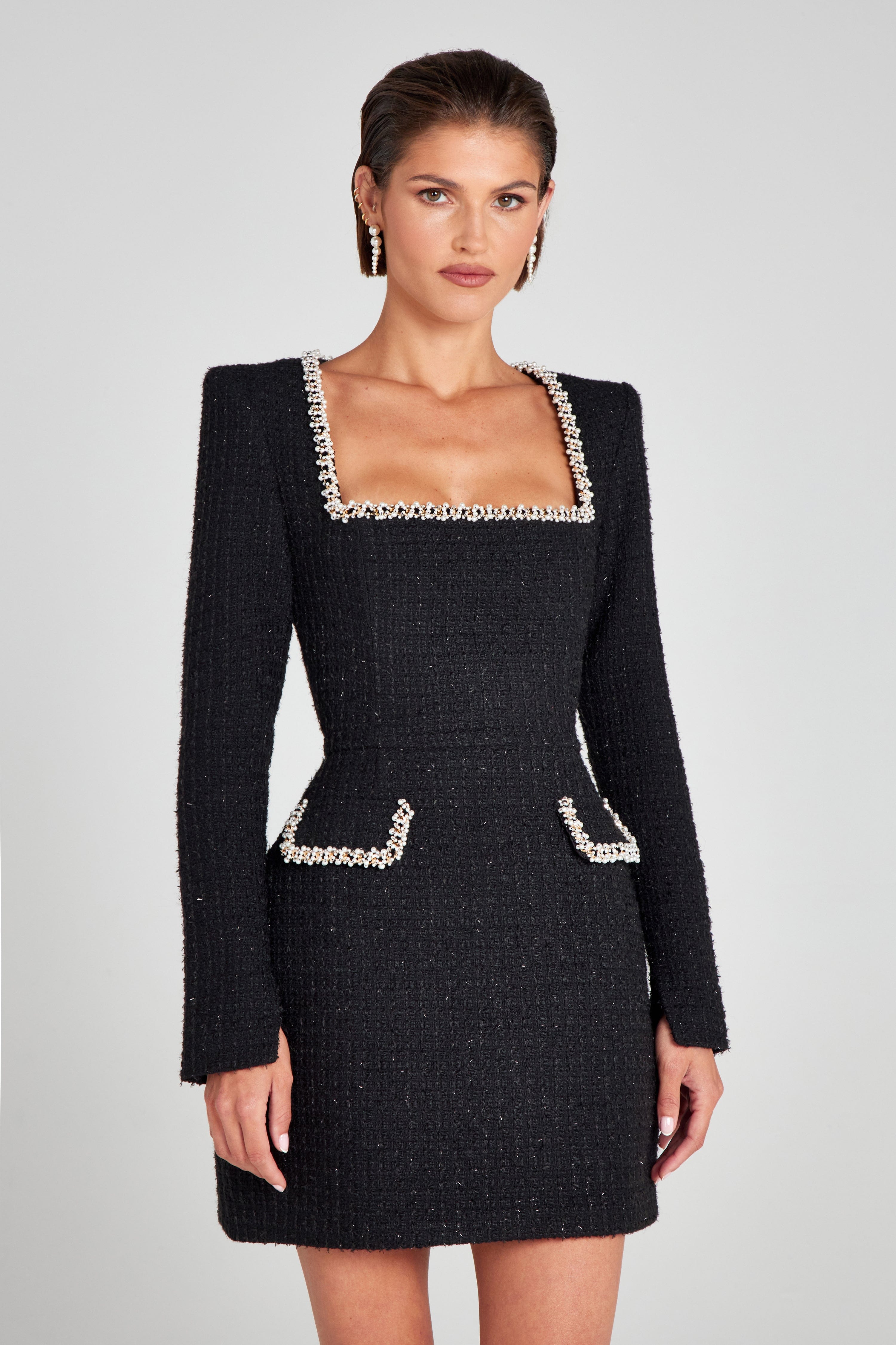 Black square neck long sleeve mini dress with pearl beaded trim and faux pocket flaps, front view