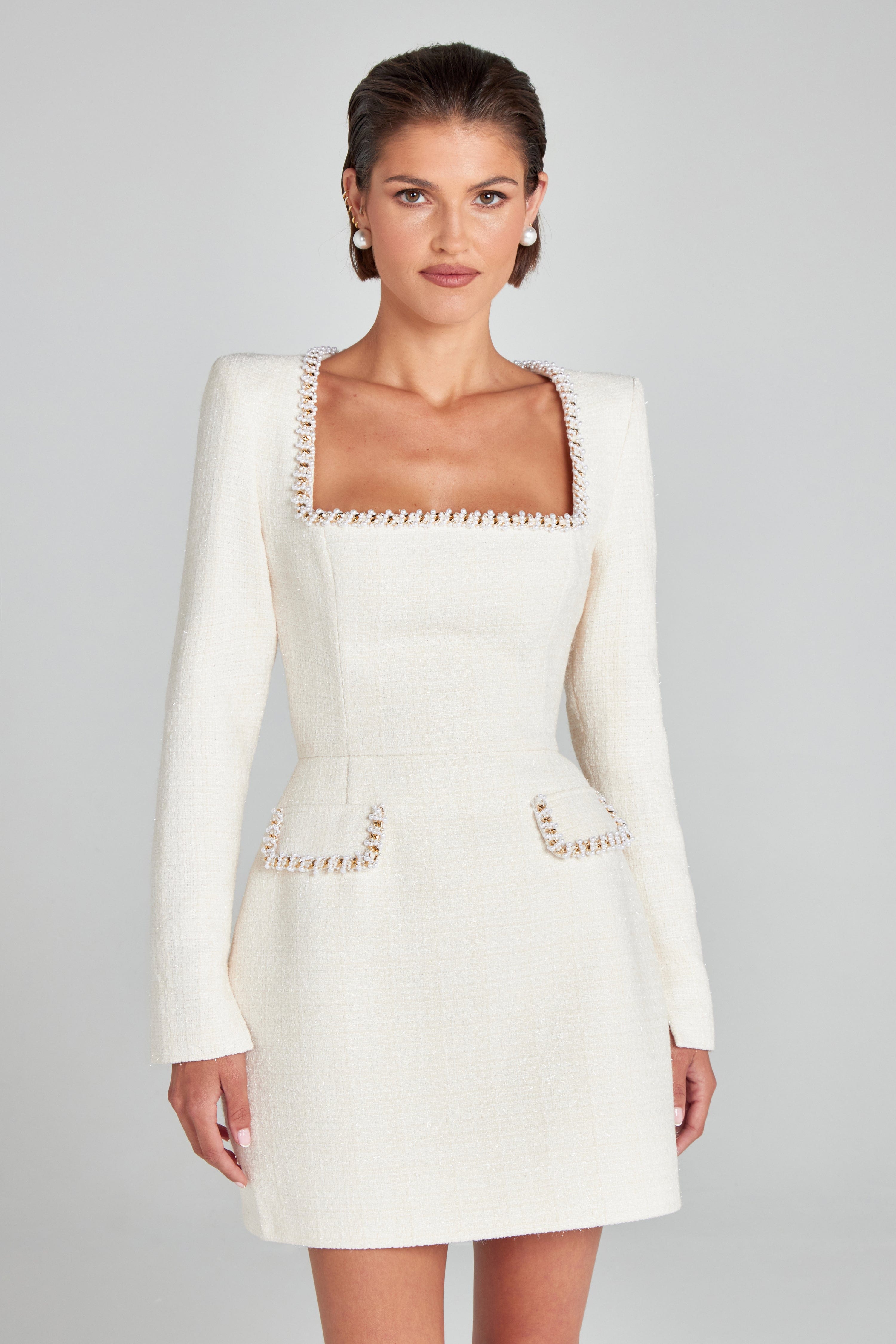 White square neck long sleeve mini dress with pearl trim neckline and pocket flaps, front view