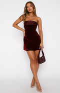 Burgundy strapless mini velvet cocktail dress with straight neckline and fitted silhouette