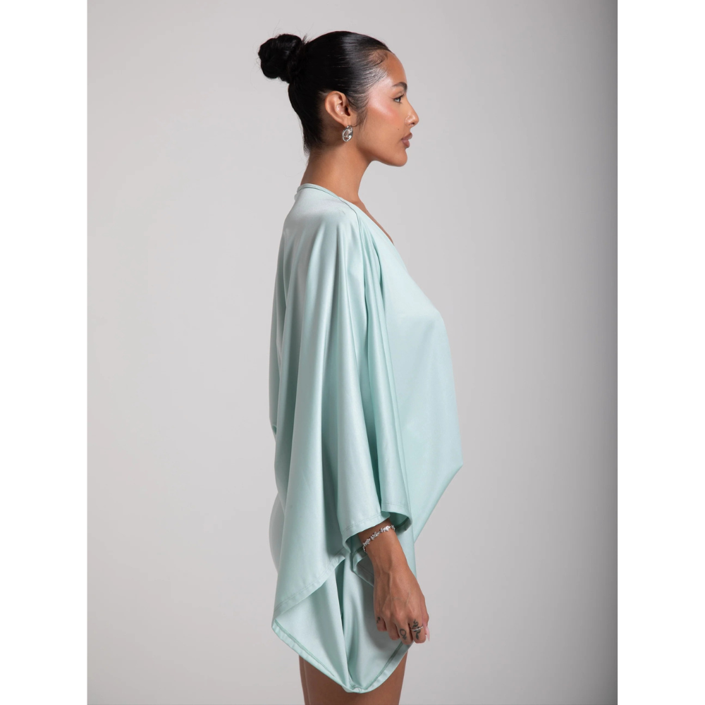 Side view of a mint v neck mini dress with draped long sleeves and loose fit