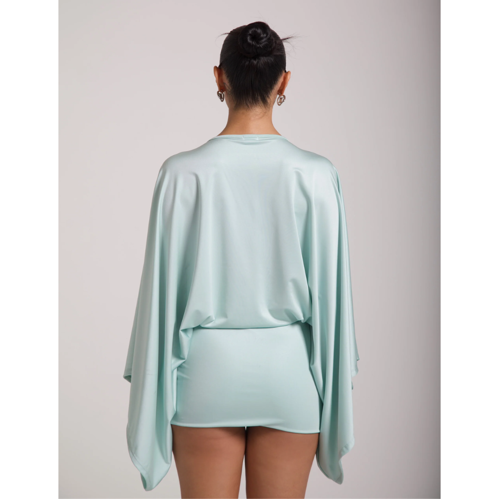 Back view of a mint cocktail mini dress with flowing sleeves and fitted hem