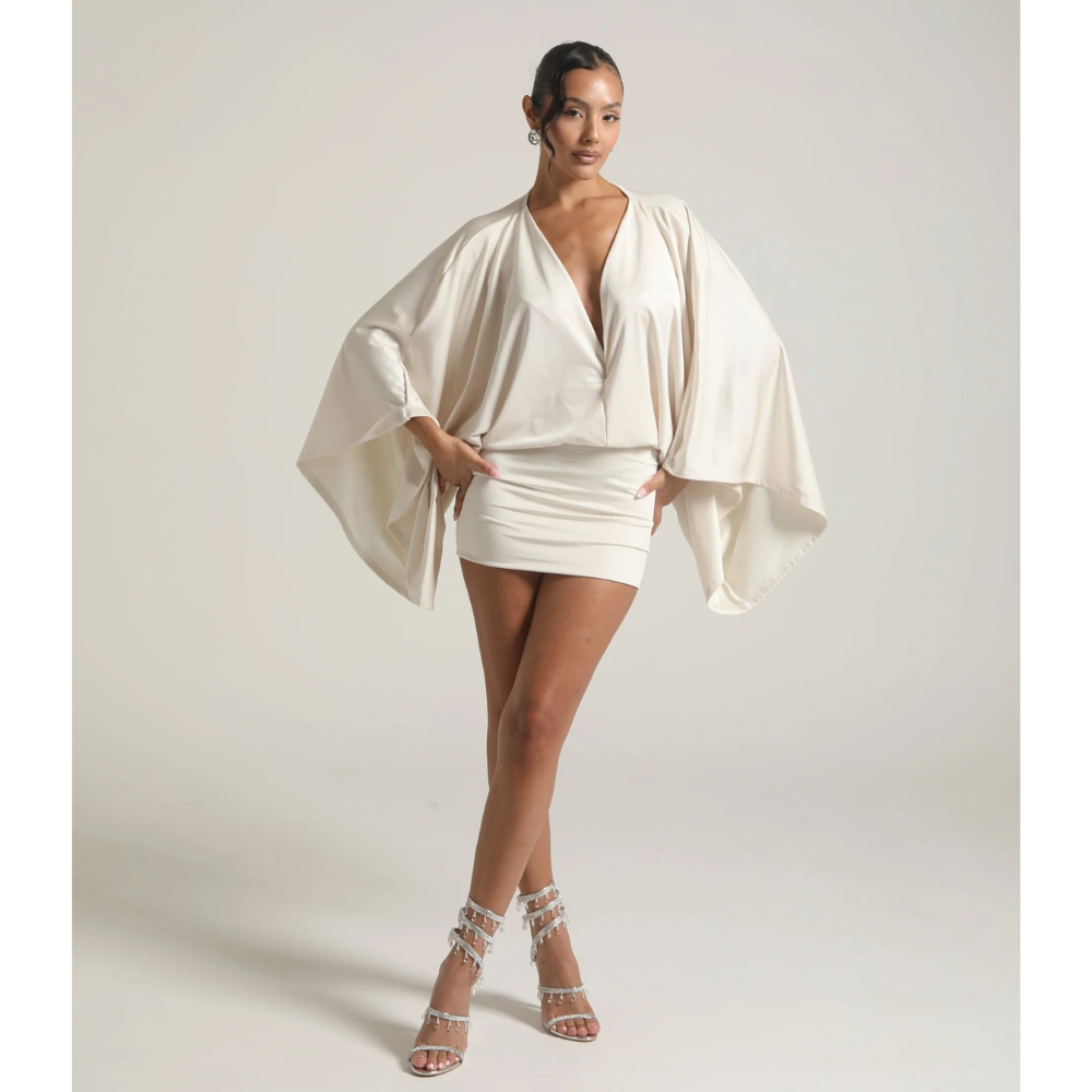 Ivory cocktail mini dress with deep V neck and wide draped sleeves, full body