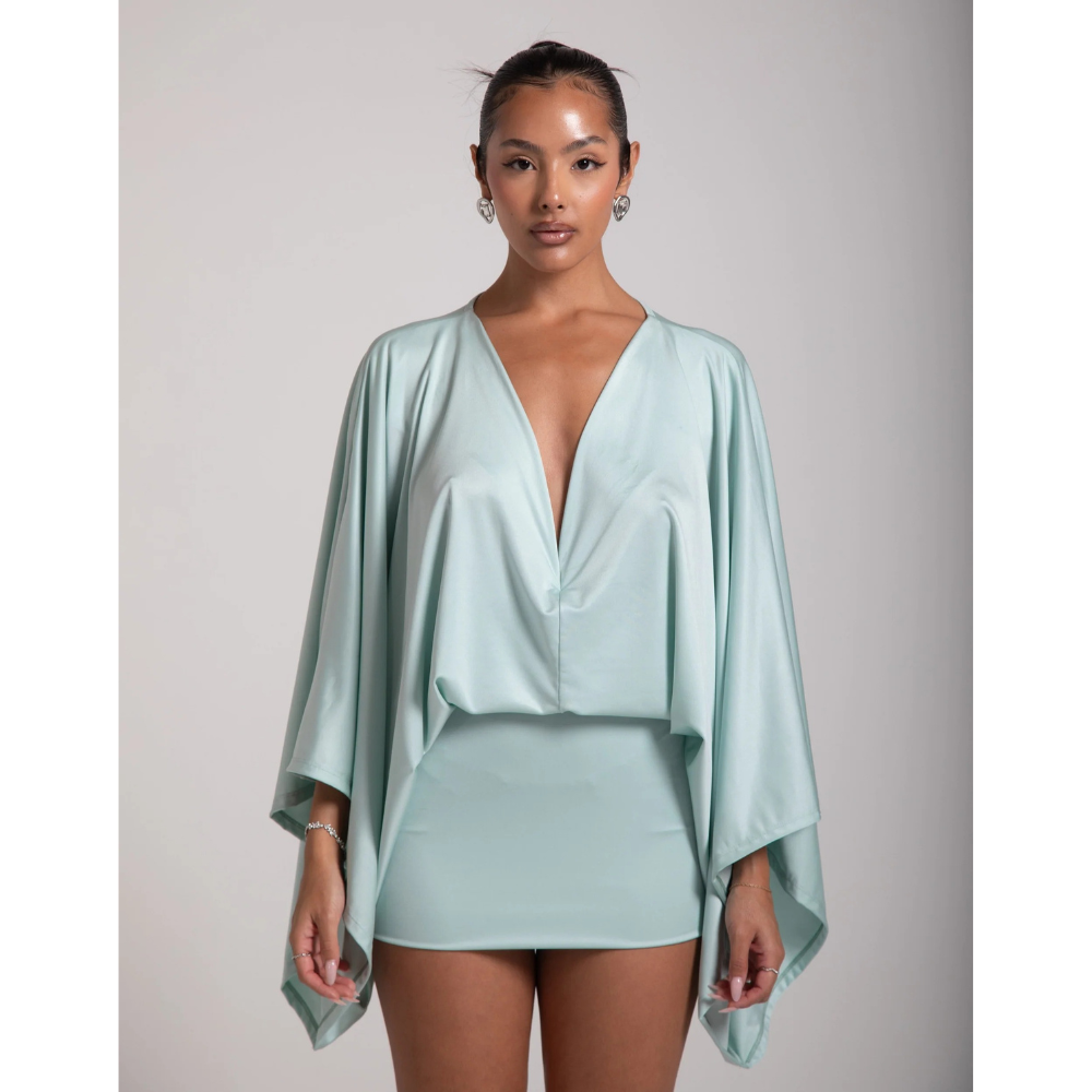 Mint green cocktail mini dress with deep V neck and flowing wide sleeves, full body