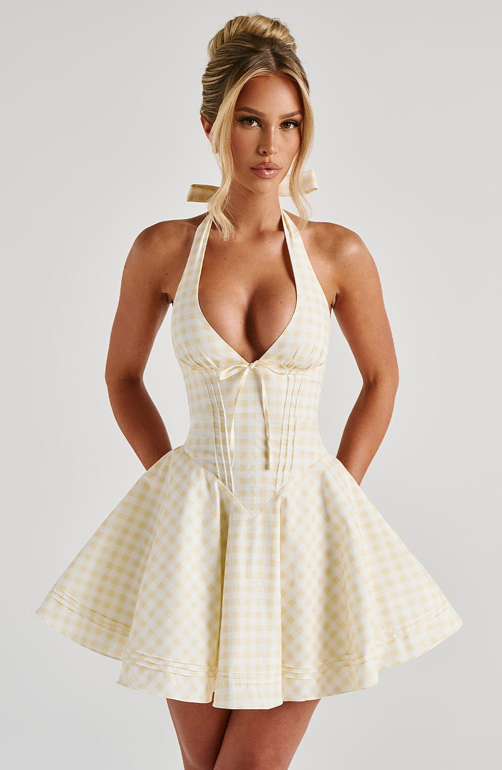 Yellow gingham plunge halter mini dress with fitted corset bodice and flared skirt, front view
