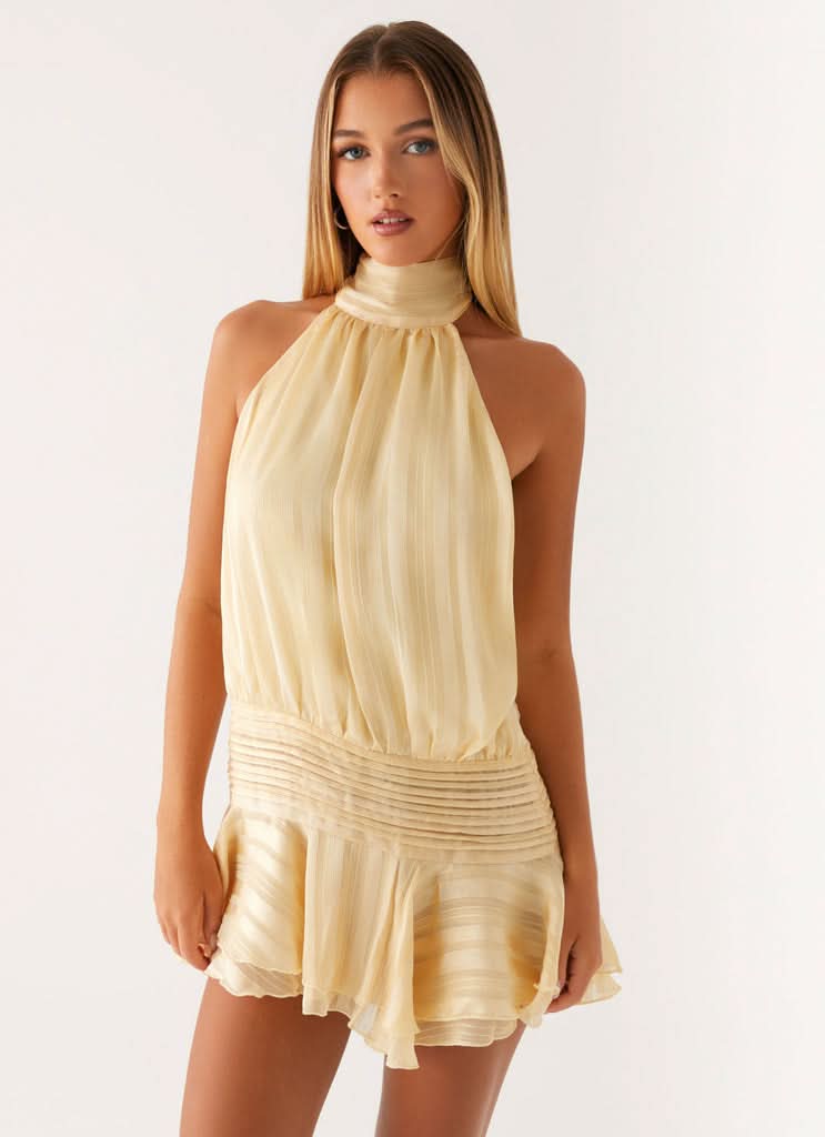 Beige halter mini dress with pleated bodice and flared hem, summer party dress