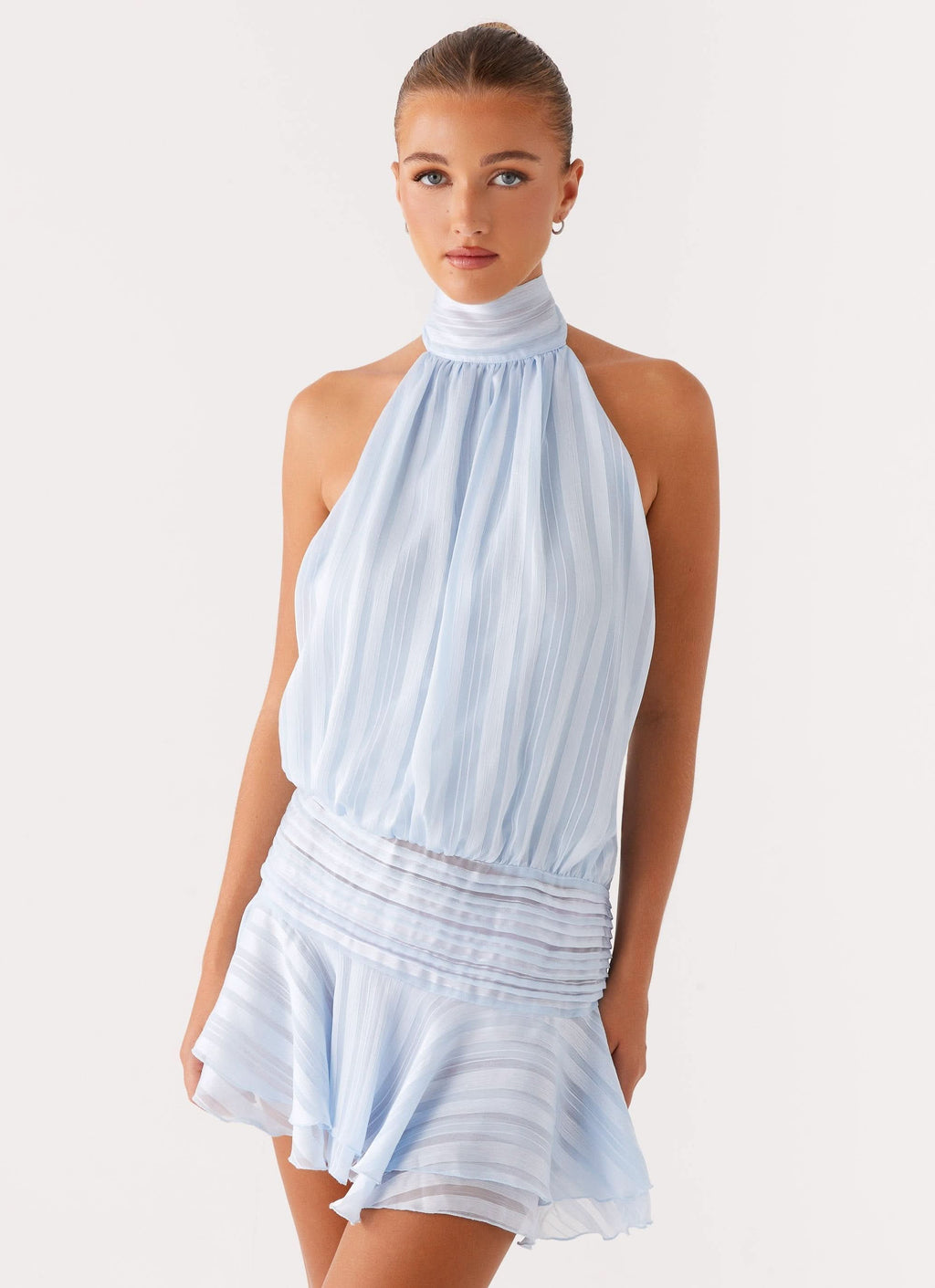 Close up of light blue halter mini dress showing sheer pleated fabric and soft drape