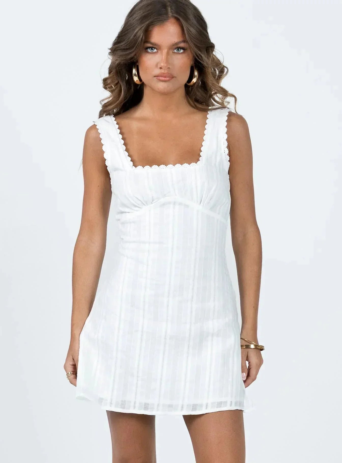 White square neck mini dress with lace trim straps and gathered bust, front view on model