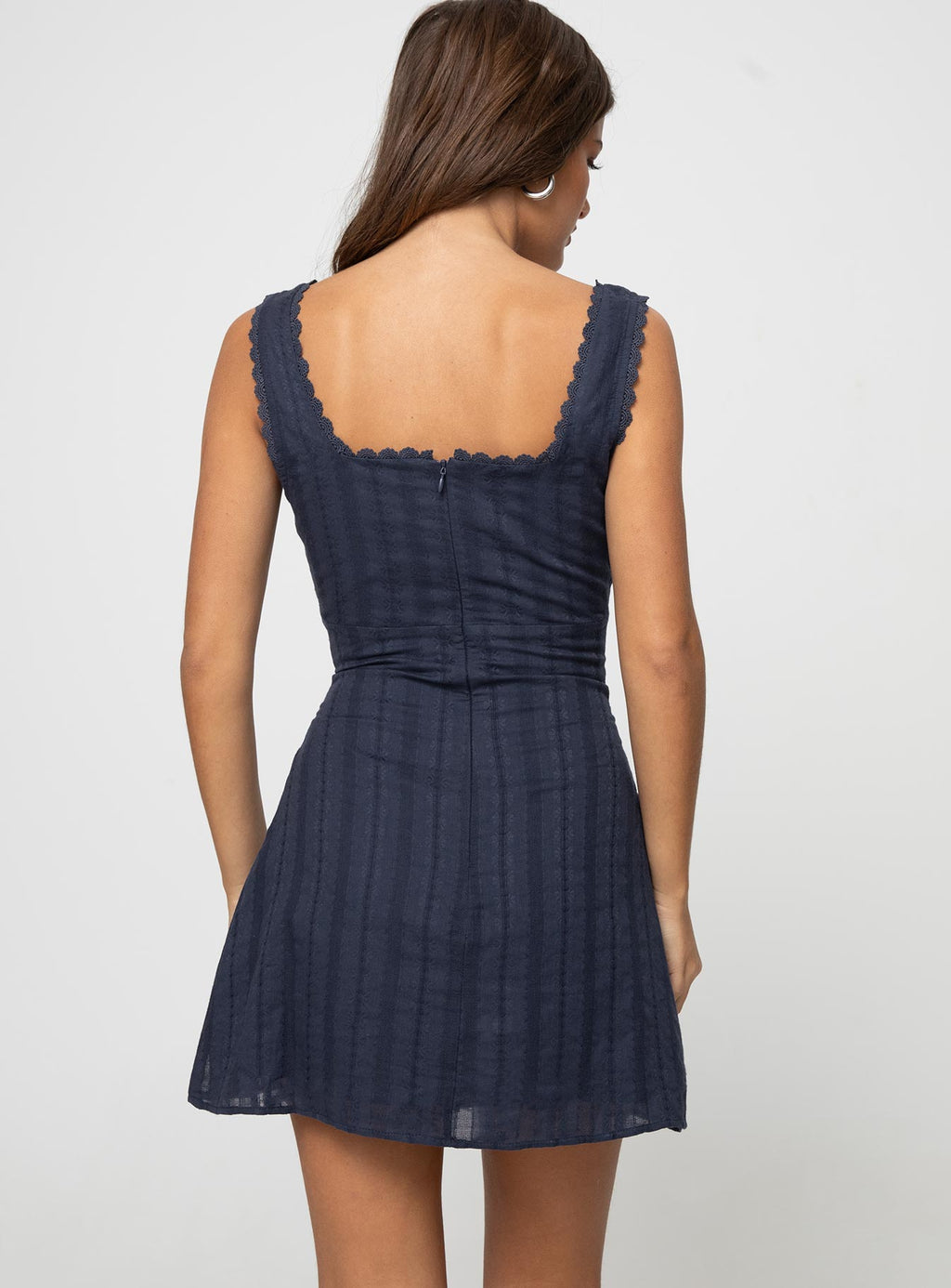 Back view of navy square neck mini dress with lace trim straps and center zipper detail