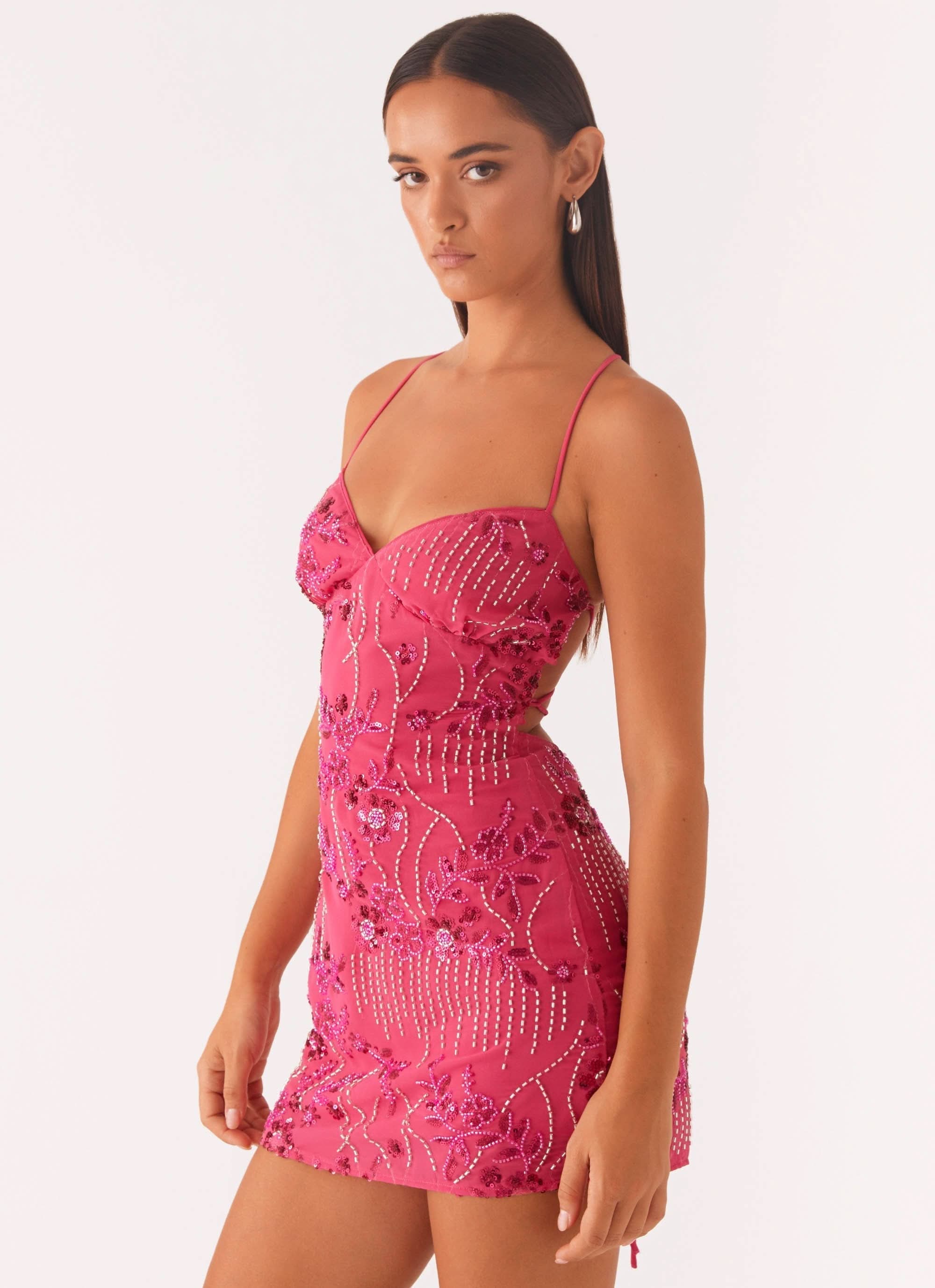 Side angle of pink wedding guest dress showing fit, floral beading, and open back