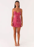 Front view of pink floral spaghetti strap mini dress with beaded detail and V-neck