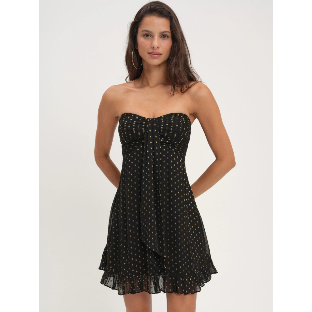 Black floral strapless mini dress with gold dots and ruffled hem for wedding guest