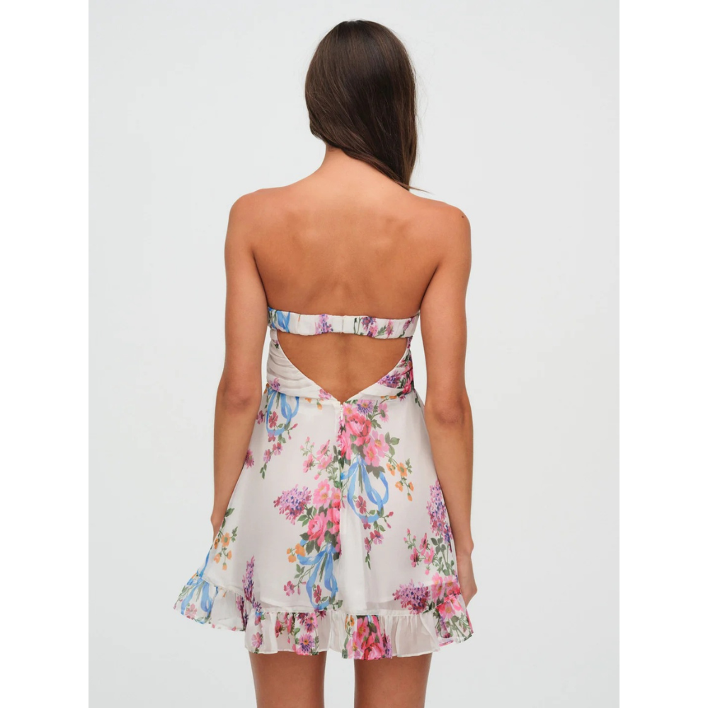 Back view of a floral strapless mini dress with open back and ruffled hem