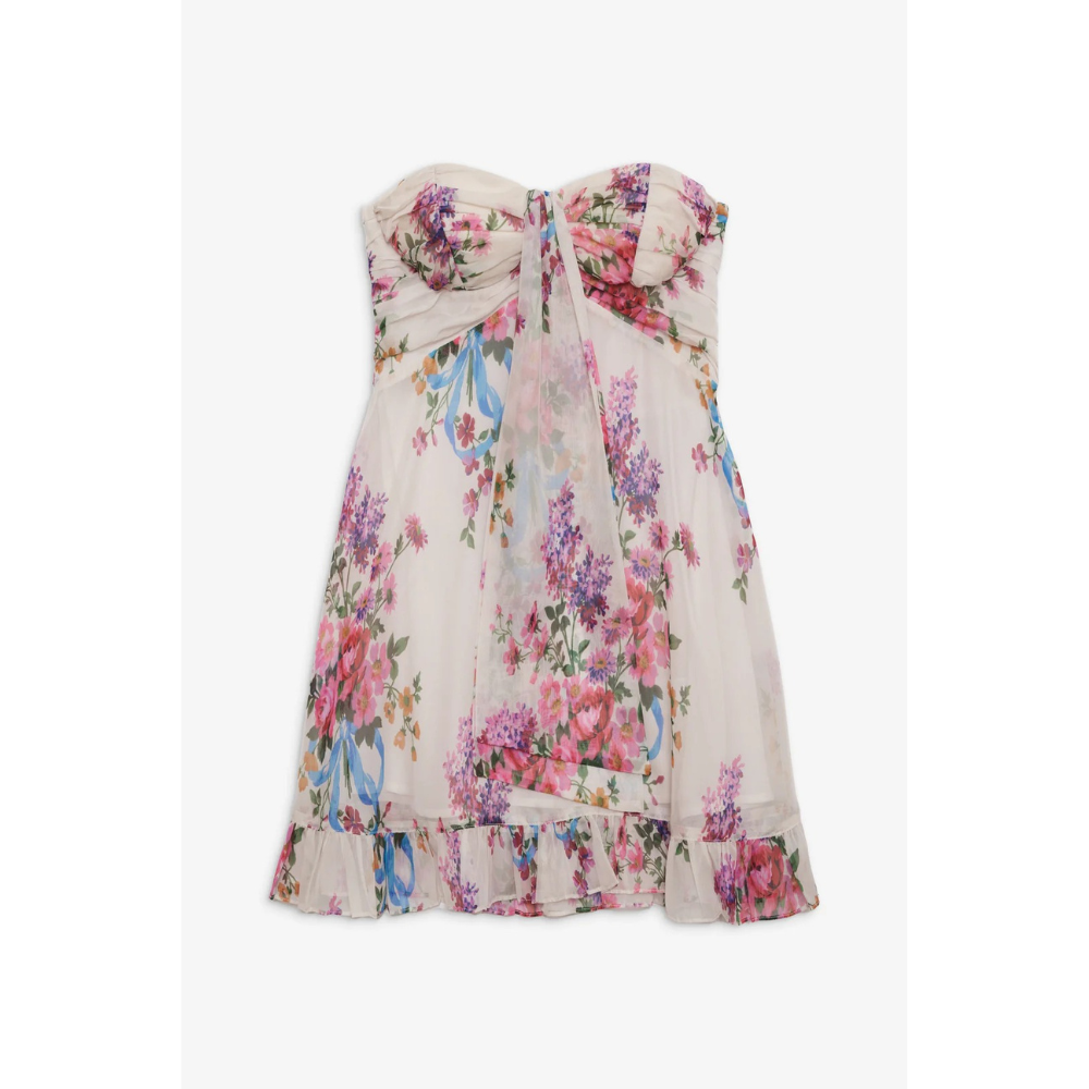 Full-length model shot wearing a floral strapless mini dress with black flats