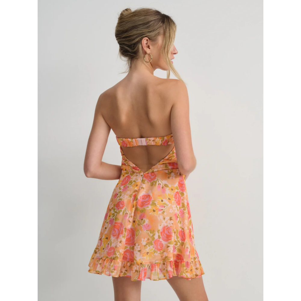 Back view of orange floral strapless mini dress with open back and ruched waist detail