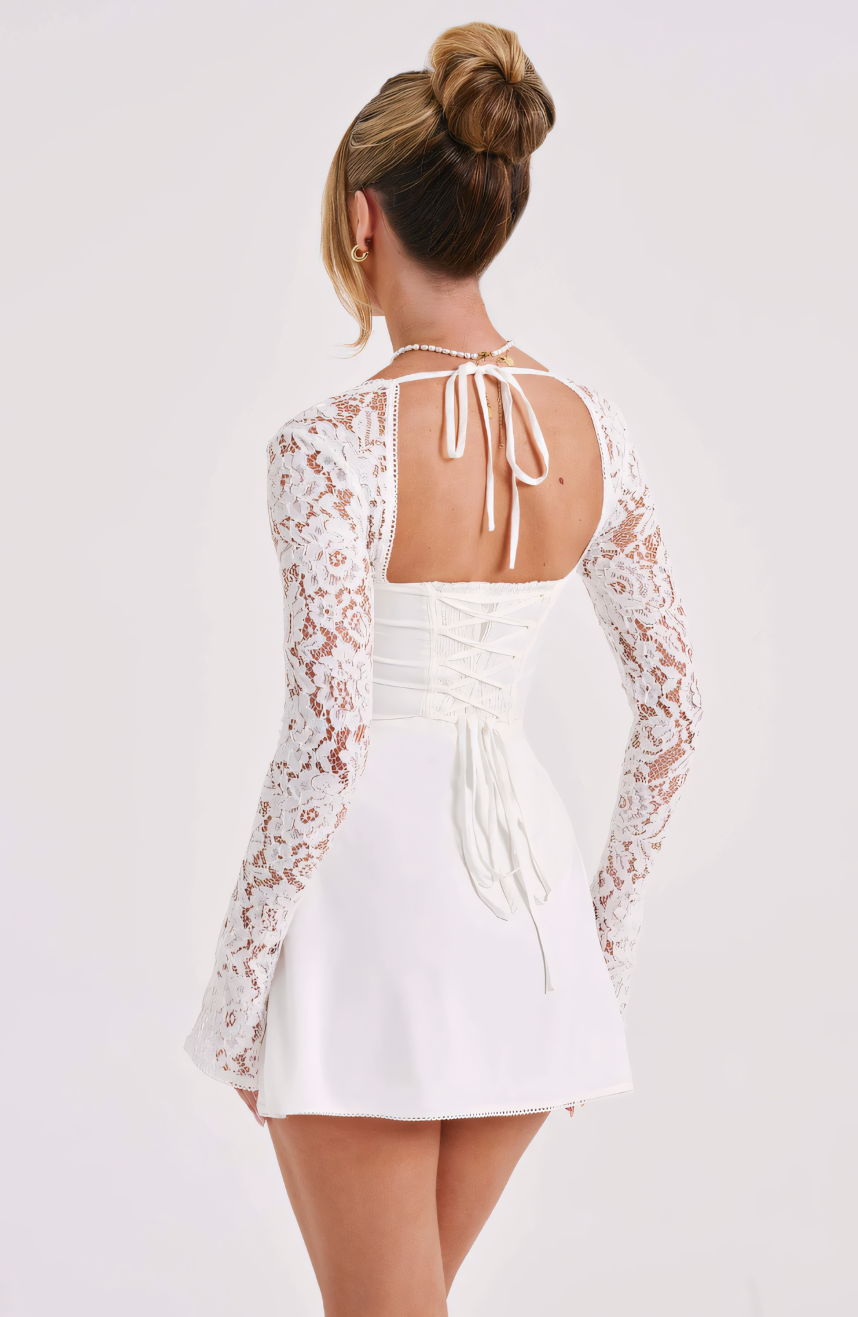 Black lace long sleeve mini dress with sweetheart neckline and fitted silhouette