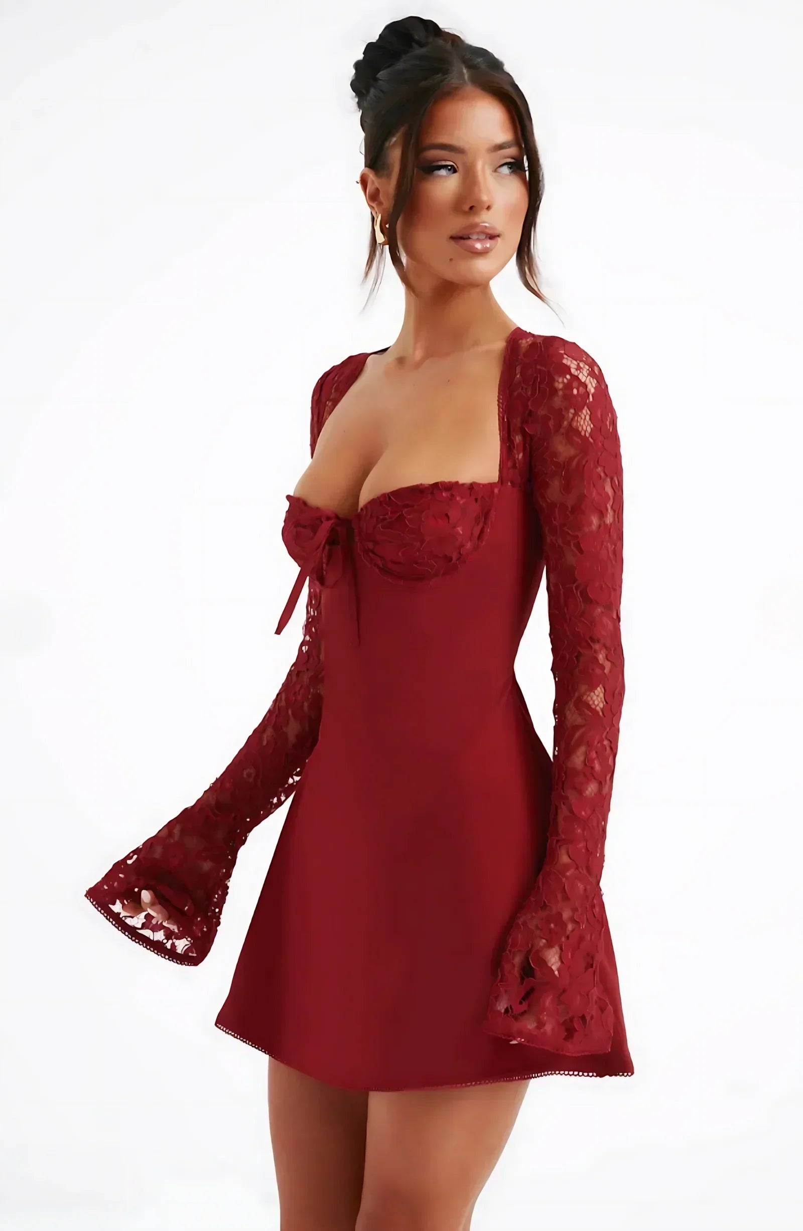 Side view of burgundy lace long sleeve mini dress showing fitted waist and short hemline