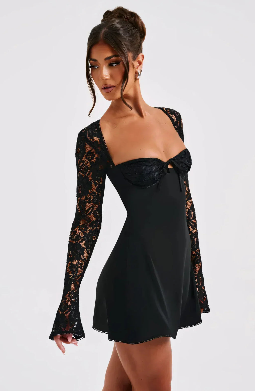 Side view black lace square neck mini dress showing sheer lace sleeves and flared hem, wedding guest dress