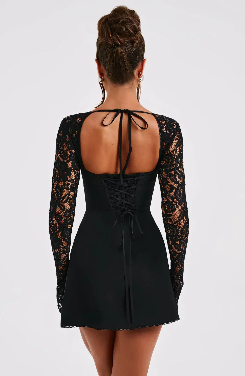 Back view black lace square neck mini dress with open back, lace-up detail, and long sleeves, wedding guest dress