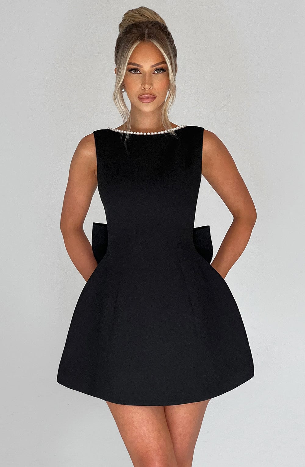 Black pearl neckline mini A-line dress, sleeveless front view with dramatic structured skirt