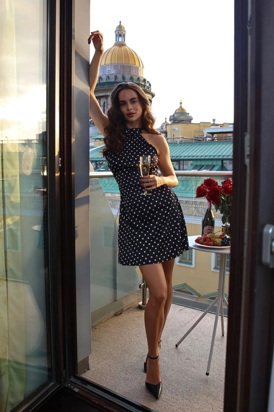 Black polka dot halter mini dress on balcony, A-line skirt wedding guest dress look