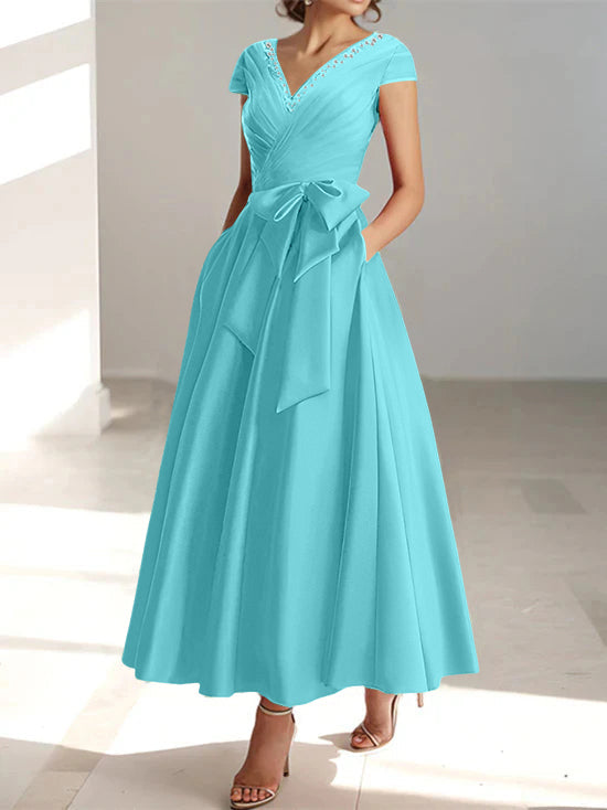 Turquoise a-line midi dress featuring v-neck, short sleeves, and functional pockets