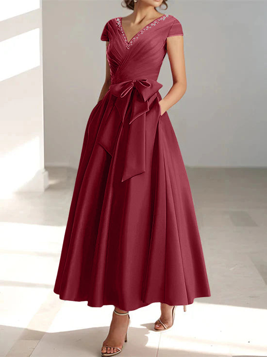 Burgundy a-line midi dress with v-neckline, short sleeves, and side pockets