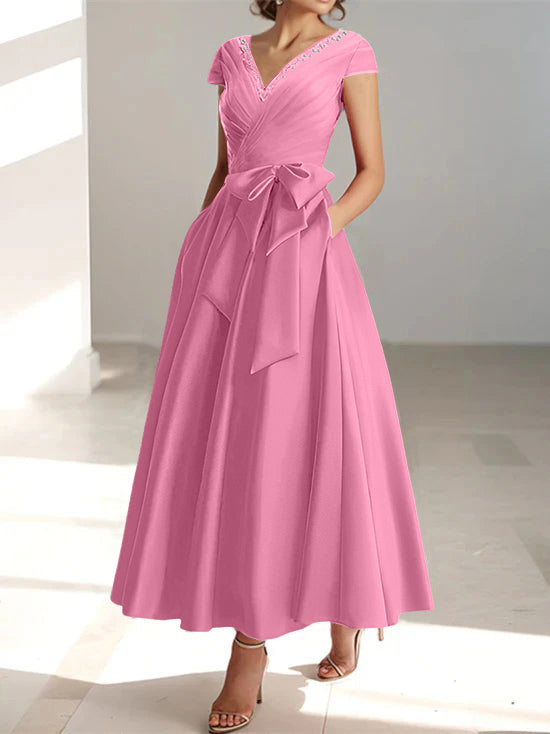 Pink a-line midi dress with v-neck, short sleeves, and side pockets