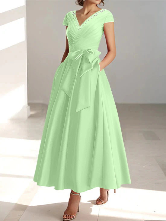Mint green a-line midi dress with v-neckline, short sleeves, and pockets