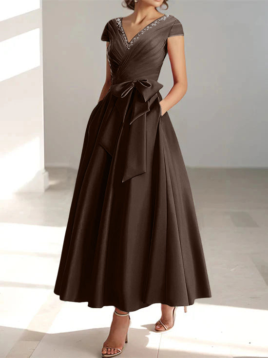 Dark brown a-line midi dress with v-neck, short sleeves, and side pockets