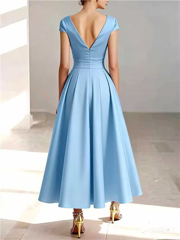 Back view of light blue A-line midi dress showing V-neck and button detail