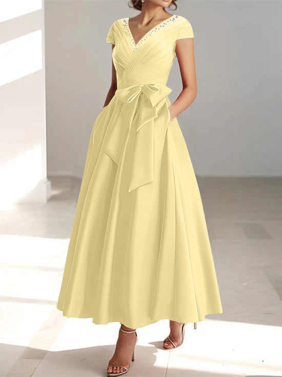 Pale yellow A-line midi dress with V-neck, short sleeves, and functional pockets