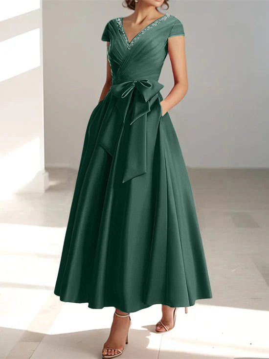Deep forest green A-line midi dress with V-neck, short sleeves, and side pockets
