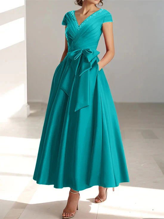 Turquoise A-line midi dress with V-neck, short sleeves, and functional pockets
