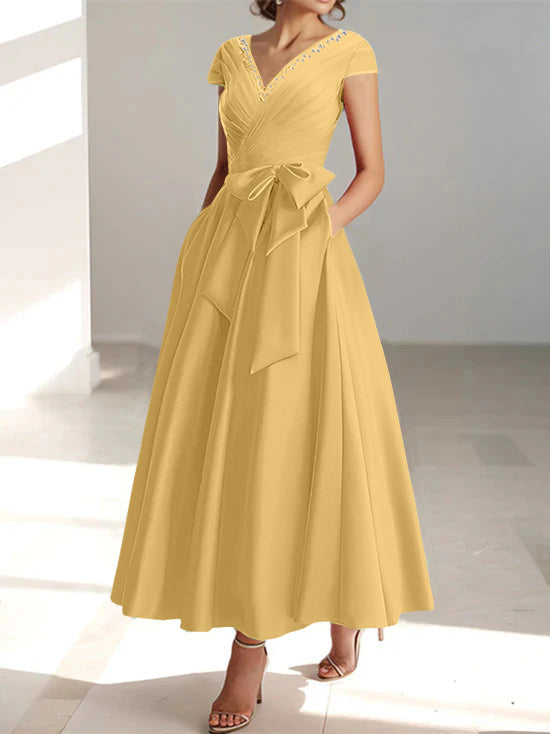 Golden yellow A-line midi dress with V-neck, short sleeves, and side pockets