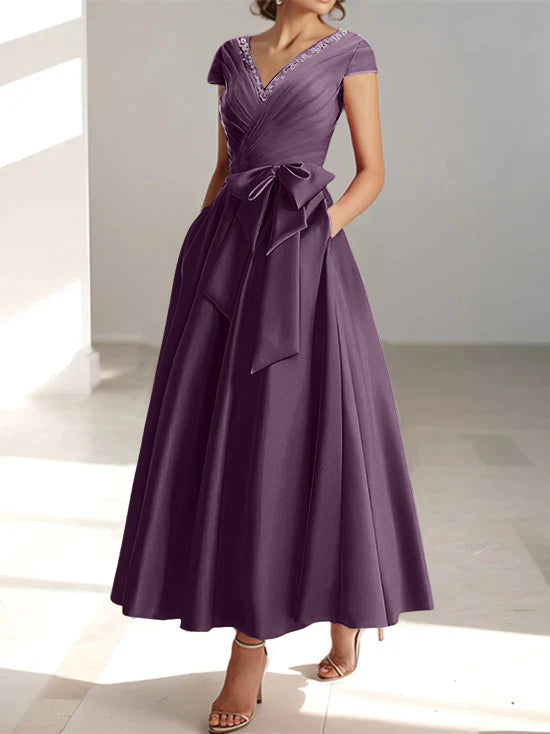 Deep plum A-line midi dress with V-neck, short sleeves, and functional pockets