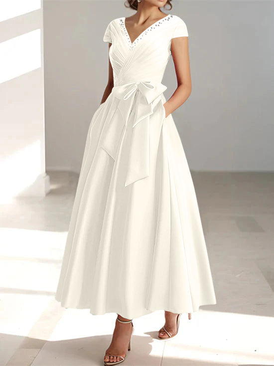 Cream wrap midi dress with V-neck, short sleeves, and functional pockets