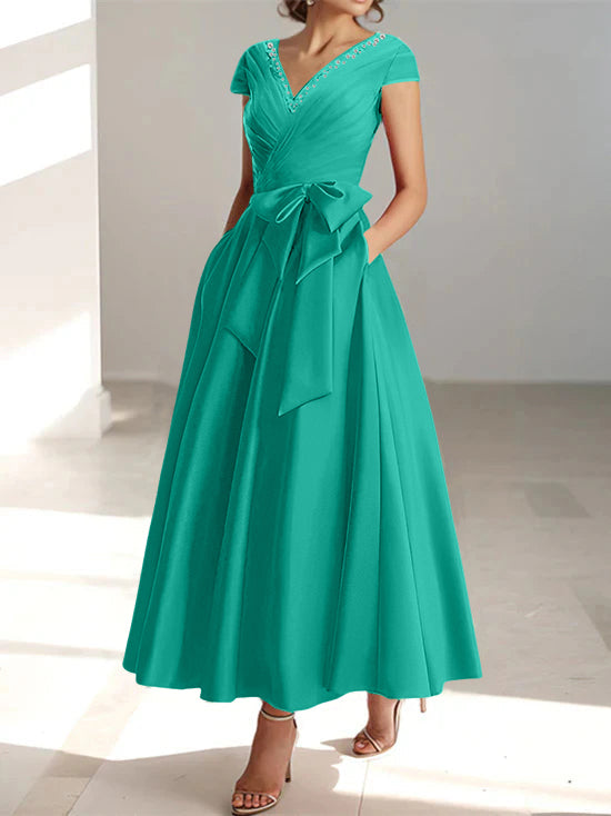Emerald green A-line midi dress with V-neck, short sleeves, and pockets