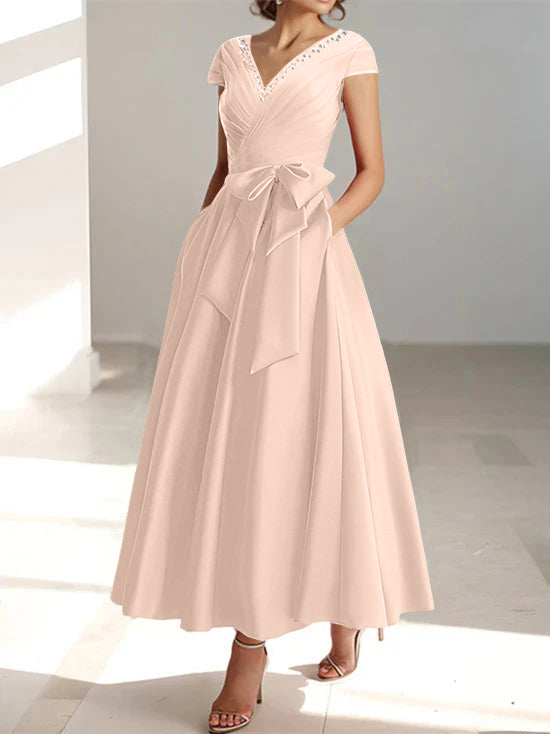 Blush pink A-line midi dress with v-neck, short sleeves, and waist tie