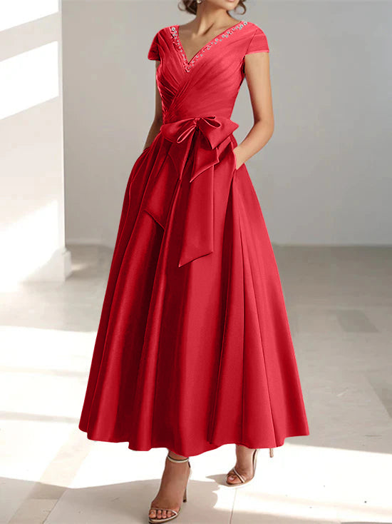 Red A-line midi dress with v-neckline, short sleeves, and waist bow