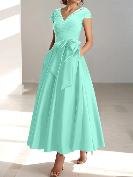 Mint green A-line midi dress with v-neckline, short sleeves, and bow