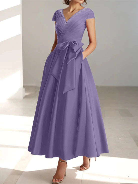 Purple a-line midi dress with v-neck, short sleeves, and side pockets